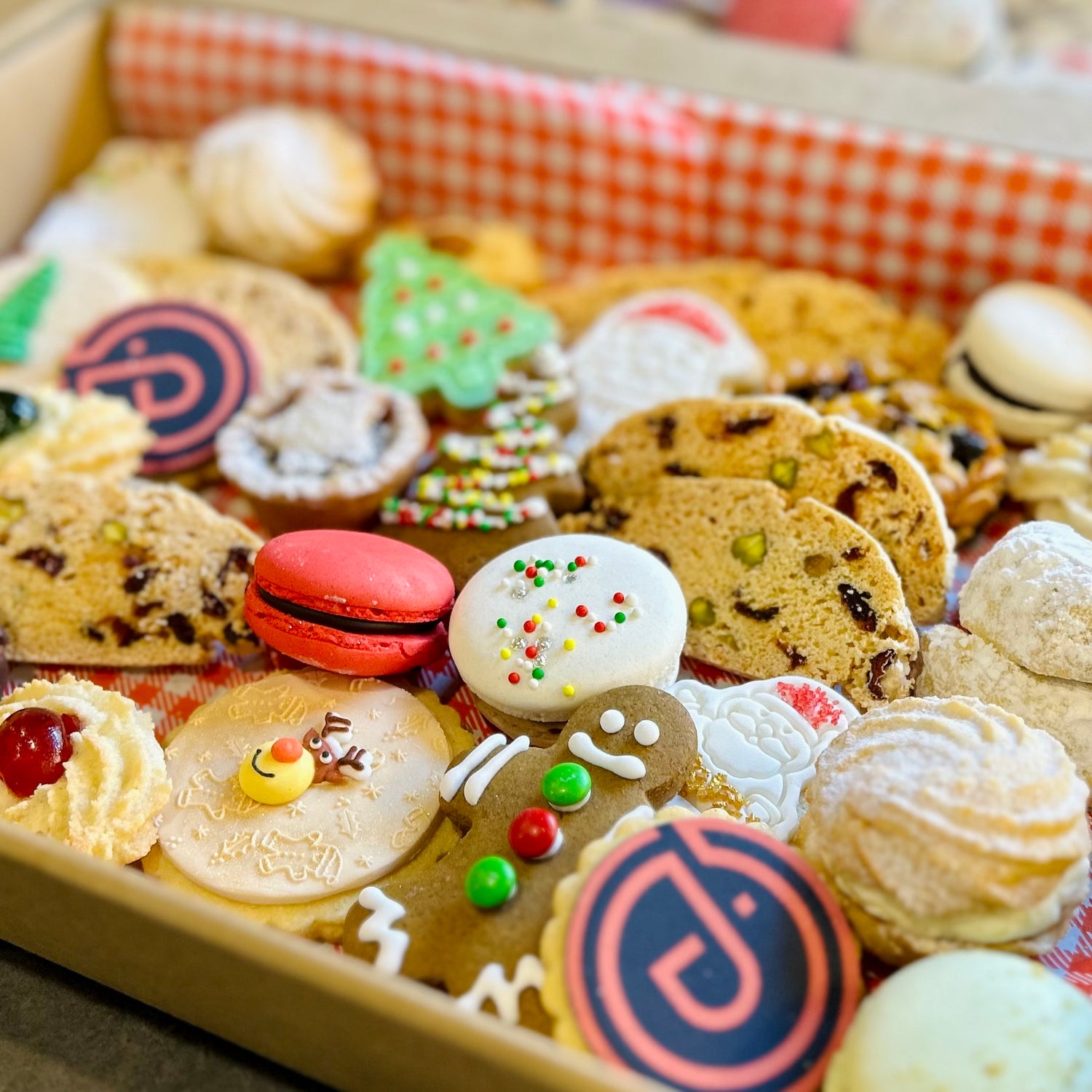 Assorted christmas cookies and branded biscuits in a box
