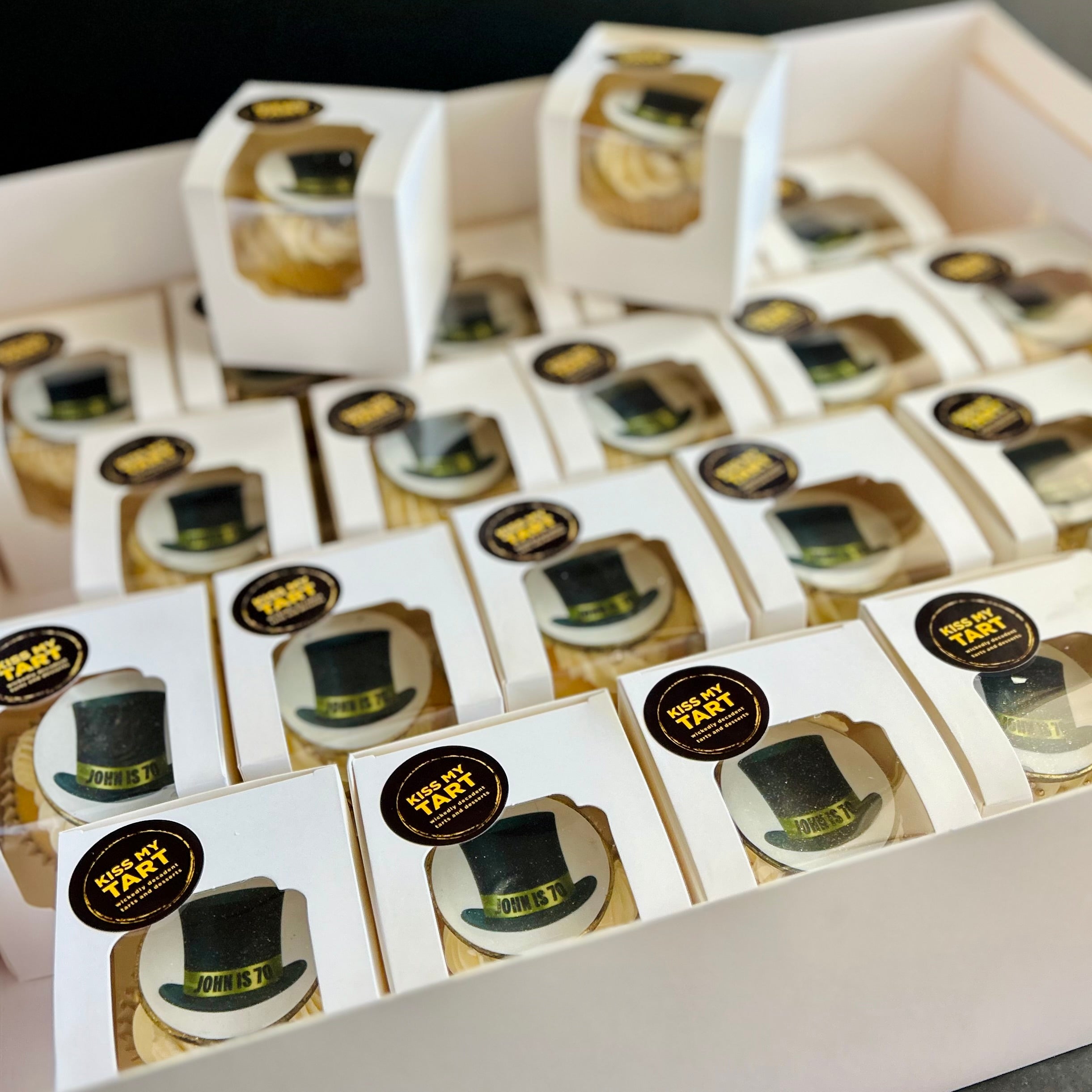 Vanilla cupcakes with top-hat toppers individually boxed