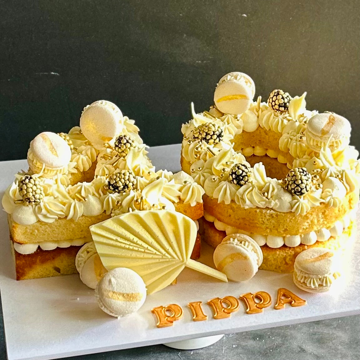 40 numeral cake with macrons and white chocolate decoration