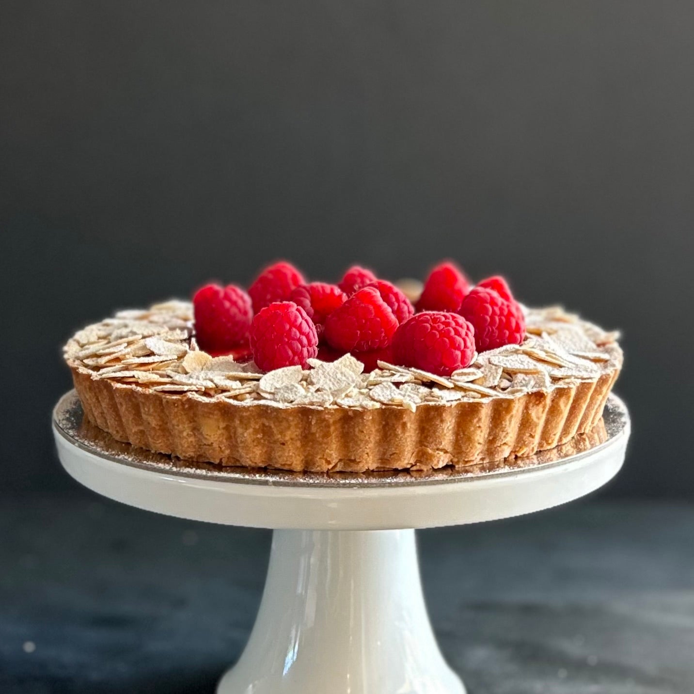 Raspberry tart with frangipane, raspberry compote. flaked almonds, fresh raspberries