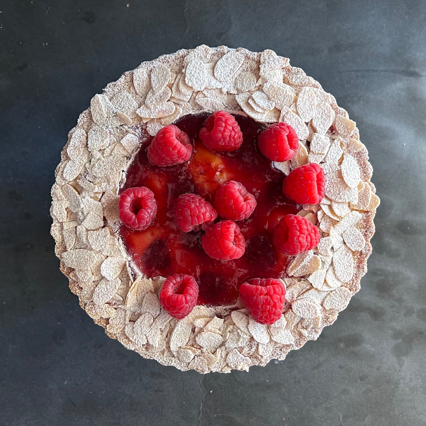Raspberry tart with frangipane, raspberry compote. flaked almonds, fresh raspberries